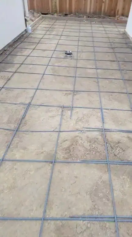 Concrete slab with rebar grid ready for masonry installation.