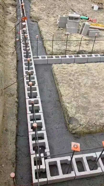 Masonry wall being built with concrete blocks and mortar for durable structures.