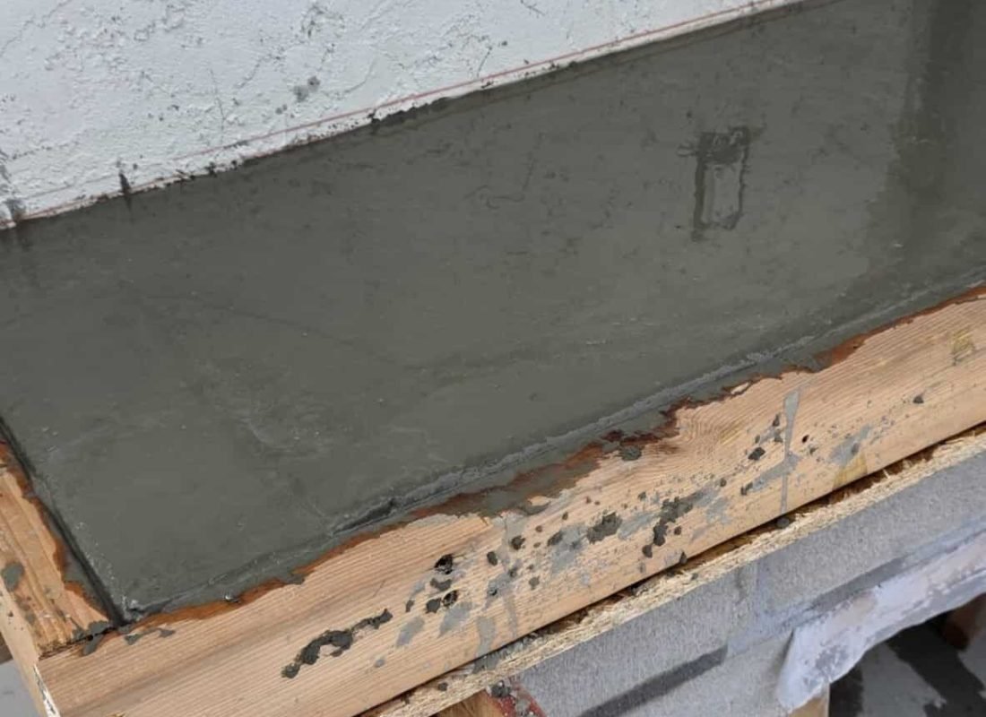 Waterproofed concrete foundation wall for building stability.